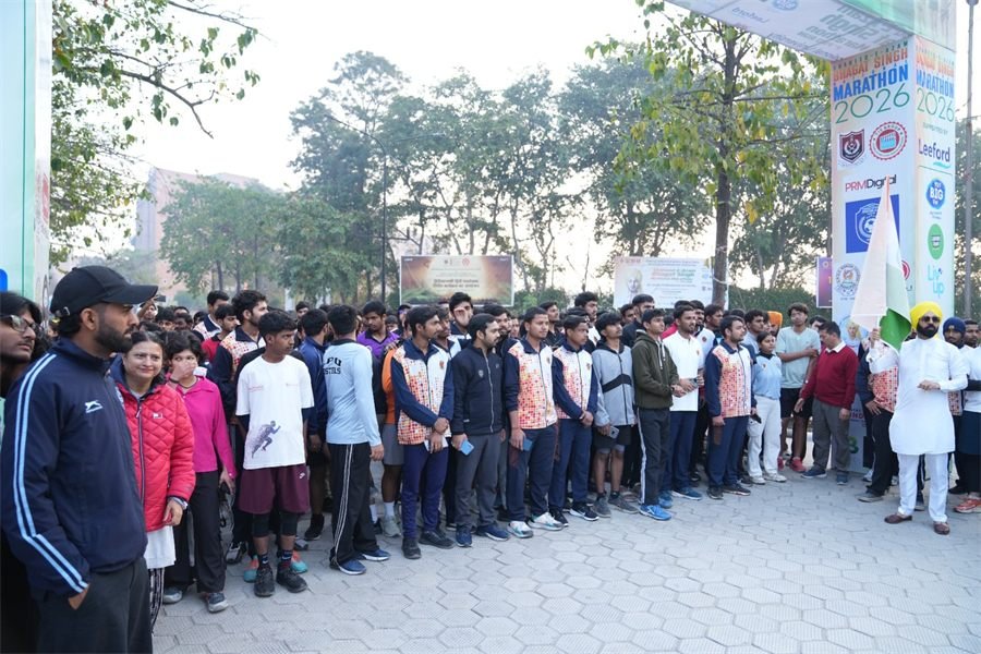 Runners and officials lined up beneath the Shaheed-e-Azam Bhagat Singh National Marathon 2026 arch before the flag-off